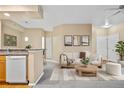 Bright and airy living room with plush neutral-colored carpet and comfortable furniture at 8422 S Upham Way # G47, Littleton, CO 80128