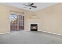 Bright, spacious living room with a cozy fireplace and sliding glass doors leading to a private balcony at 8422 S Upham Way # G47, Littleton, CO 80128