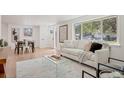 Living room features hardwood floors, comfy sofa, and large windows at 34 University Dr, Longmont, CO 80503