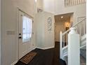 Bright entryway with dark hardwood floors and staircase at 245 Dunhill St, Castle Rock, CO 80104