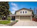 Charming two-story home with an attached garage and a well-manicured front lawn, perfect for Gathering living at 7863 W Quarto Ave, Littleton, CO 80128