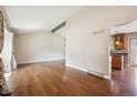 Spacious living room with high ceilings, hardwood floors, and natural light, ideal for entertaining at 7863 W Quarto Ave, Littleton, CO 80128