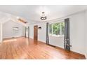 Bright living room with vaulted ceilings, wood floors, a skylight, and large windows offering ample natural light at 457 S Locust St, Denver, CO 80224