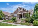 Beautiful home with a well-manicured front yard featuring stone steps and a covered porch at 27485 E Nova Pl, Aurora, CO 80016