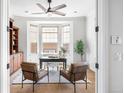 Bright home office featuring built-in bookshelves, bay window, and neutral decor at 27485 E Nova Pl, Aurora, CO 80016