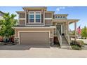 Charming two-story home featuring a covered entry, attached garage, and landscaped front yard at 10560 Waco St, Commerce City, CO 80022