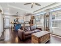 Open-concept living room and kitchen, features an island and large windows for ample natural light at 10560 Waco St, Commerce City, CO 80022