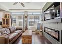 Beautiful living room with a modern fireplace and an abundance of natural light at 10560 Waco St, Commerce City, CO 80022