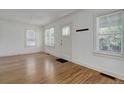Bright living room featuring hardwood floors, fresh paint, and ample natural light at 150 S Garfield St, Denver, CO 80209