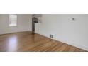 Open-concept living area with hardwood floors, stainless appliances, and bright, modern design at 150 S Garfield St, Denver, CO 80209