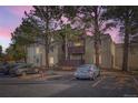 Tan apartment building with balconies, shade trees, and marked parking spaces at 9700 E Iliff Ave # C20, Denver, CO 80231