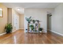 Bright foyer featuring hardwood floors, neutral walls, and stylish decor; with ample natural light at 12520 W Virginia Ave, Lakewood, CO 80228