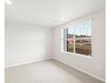 Cozy bedroom with plush carpet and a bright window overlooking the outdoors at 14422 Pansy Loop, Morrison, CO 80465