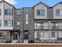 Modern townhome showcases varied textures and private front patios at 14422 Pansy Loop, Morrison, CO 80465
