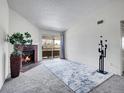 Bright living room featuring a cozy fireplace, neutral carpet, and sliding glass doors to a balcony at 1094 S Dearborn St # 301, Aurora, CO 80012
