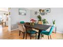 Bright dining room featuring hardwood floors and a dark wood table at 9506 Castle Ridge Cir, Highlands Ranch, CO 80129