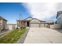Charming single-Gathering home featuring a well-manicured lawn, a three-car garage, and a welcoming covered front porch at 7108 Morrison Dr, Frederick, CO 80530