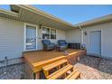 Cozy outdoor deck with seating, accessed by steps with brick walkway to house door at 7716 Shenandoah Dr, Elizabeth, CO 80107