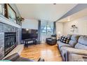 Comfortable living room with hardwood floors, a fireplace, and a large TV for relaxing evenings at 7716 Shenandoah Dr, Elizabeth, CO 80107