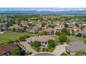 Aerial view of a luxury home with a circular driveway surrounded by lush landscaping and neighborhood at 2378 Plumb Pl, Erie, CO 80516