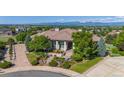 Expansive home exterior featuring professional landscaping and a circular driveway at 2378 Plumb Pl, Erie, CO 80516