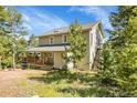 Charming two-story home with a wrap-around deck, nestled in a natural setting with mature trees at 6979 Weasel Way, Evergreen, CO 80439