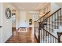 Welcoming foyer featuring hardwood floors, a staircase, and natural light at 10631 Autumnsong Ct, Highlands Ranch, CO 80126