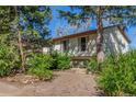 Traditional home featuring mature trees, offering shade and curb appeal to the property at 683 Sunnyside St, Louisville, CO 80027
