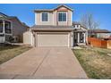 Charming two-story home with a well-maintained lawn and a two-car garage at 16277 Blueleaf Pl, Parker, CO 80134