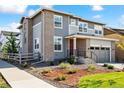 Charming two-story home with a well-maintained yard, modern brick, gray siding, and a two-car garage at 8102 Adams Fork Ave, Littleton, CO 80125