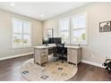 Bright home office with large windows, modern desk, and neutral color palette at 8102 S Adams Fork Ave, Littleton, CO 80125