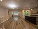 Open-concept living area with a fireplace, island kitchen, and abundant natural light at 12652 Glencoe St, Thornton, CO 80241