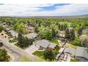 A beautiful aerial view of a home surrounded by lush trees in a vibrant neighborhood at 10482 W 75Th Ave, Arvada, CO 80005