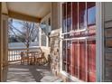 Relaxing front porch with small table and chairs at 8588 W Quarles Pl, Littleton, CO 80128