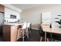 Open concept floor plan with wood floors, a kitchen peninsula and barstool seating plus modern appliances at 2880 Zuni St # 406, Denver, CO 80211