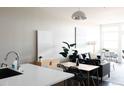 Inviting living room and dining area with neutral paint colors, modern furnishings and plenty of natural light at 2880 Zuni St # 406, Denver, CO 80211