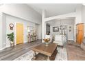 Open concept living room and dining area with hardwood floors at 16351 Umpire St, Hudson, CO 80642