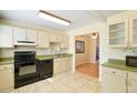 Charming kitchen featuring sleek black appliances, tile flooring, light-colored cabinets and green countertops at 5711 W 92Nd Ave # 30, Westminster, CO 80031