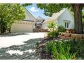Well-maintained home featuring a circular entryway, stone accents, and a beautifully landscaped front yard with flowers at 4944 W 107Th Loop, Westminster, CO 80031