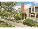 Charming townhome with brick accents, dormer windows, and a well-manicured front yard at 1950 S Helena St # D, Aurora, CO 80013