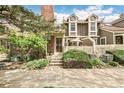 Inviting townhome with a brick facade, white picket fence, and lush landscaping at 1950 S Helena St # D, Aurora, CO 80013