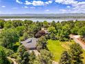 Stunning aerial view showcasing the property near a lake and mountain views at 5350 Yellowstone St, Bow Mar, CO 80123