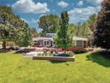 Backyard, featuring a seating area, lush lawn, and beautiful landscaping at 5350 Yellowstone St, Bow Mar, CO 80123
