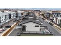 Bird's eye view of townhomes, highlighting the rooftop decks and neighborhood layout, and street view at 8742 E 47Th Ave, Denver, CO 80238