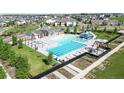 A resort-style community pool with waterslides and multiple lounge areas surrounded by green spaces at 8742 E 47Th Ave, Denver, CO 80238
