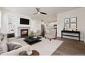 Cozy living room featuring a fireplace, hardwood floors, ceiling fan, and neutral tones for a warm ambiance at 11896 Meade Ct, Westminster, CO 80031