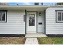 Close-up of the front door with the house number and modern exterior lighting at 3342 S Flamingo Way, Denver, CO 80222