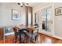 Small dining area with wooden table and chairs, access to balcony at 1630 N Clarkson St # 320, Denver, CO 80218