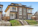 Modern duplex featuring a rooftop deck, large windows, and a well-manicured front yard at 4211 Vallejo St, Denver, CO 80211