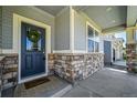 Inviting front door with stone accents and a wreath, welcoming visitors into the home at 3086 Kestrel St, Brighton, CO 80601